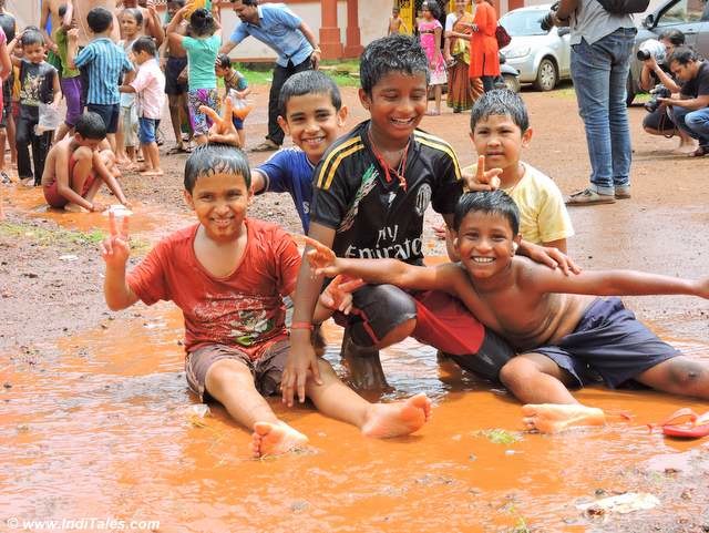 Boys playing in mud at Chikal Kalo, Goa