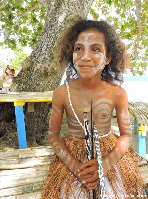 Painted face of a young tribal musician